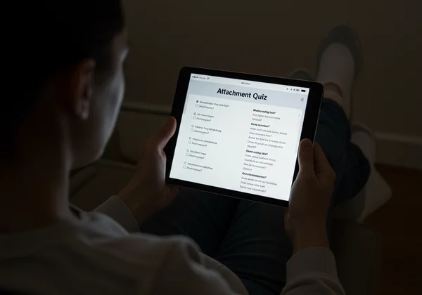 Person doing an online attachment style quiz on a tablet.