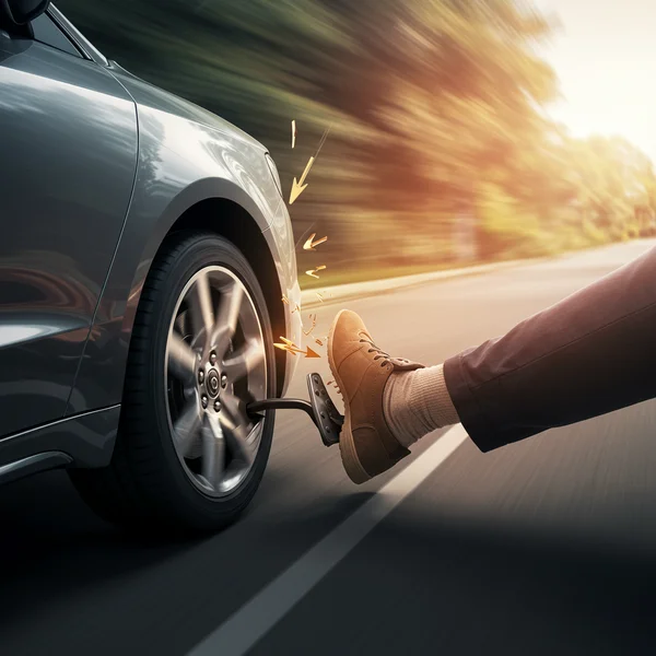A car with one foot on gas, one on brake, representing conflict